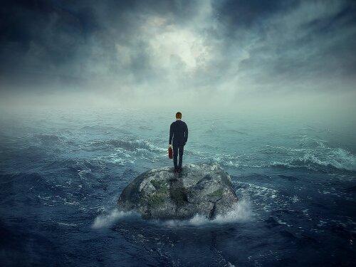 Failure crisis concept and lost business career education opportunity. Lonely young man on a rock cliff island surrounded by an ocean storm waves-1