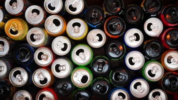 Many opened and drunk cans of different energy drinks