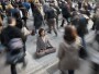 Mixed race businesswoman practicing yoga in busy urban crosswalk