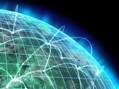 Glowing lines over the globe representing telecom networks such as those of AT&T and Verizon