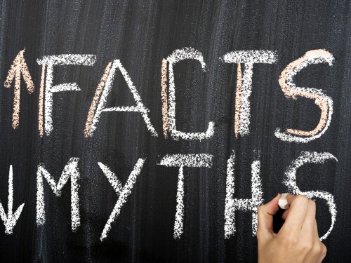 Myths and facts written on a chalkboard, money myths