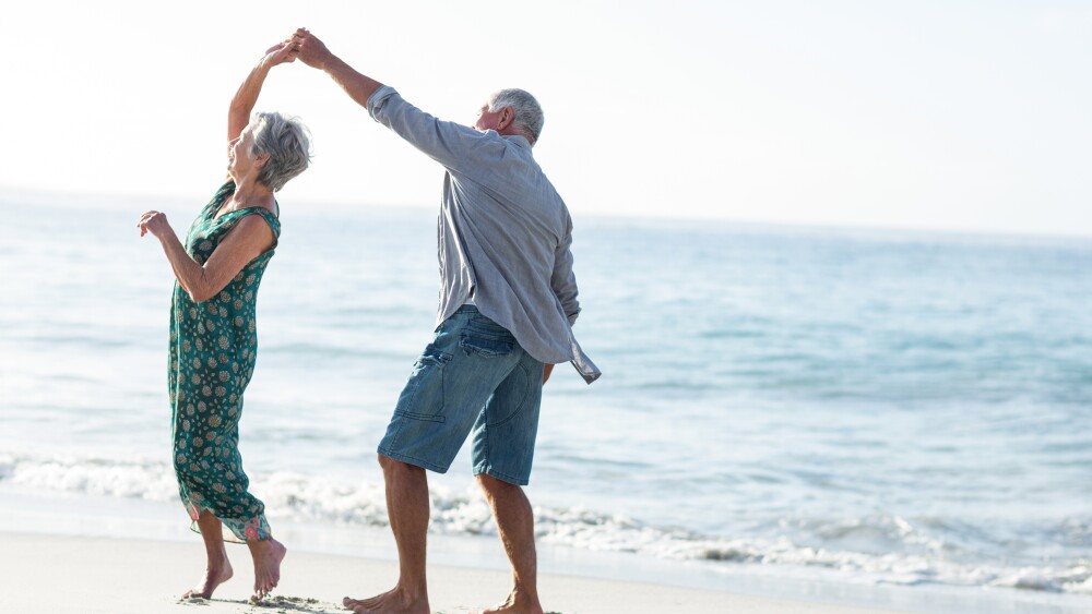 Senior couple dancing at the beach