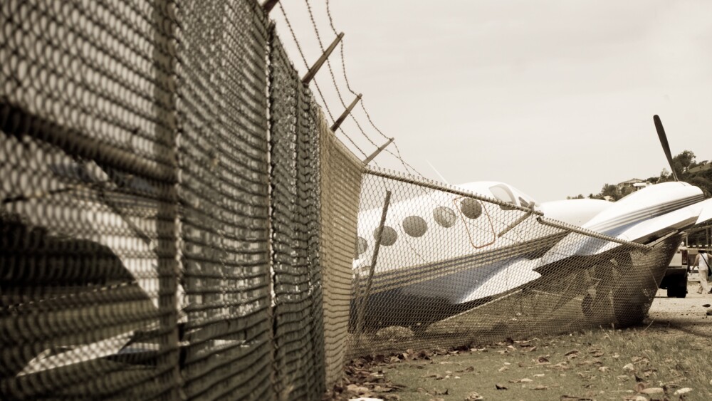 small plane crashes through fence in emergency landing, hard landing, crash landing