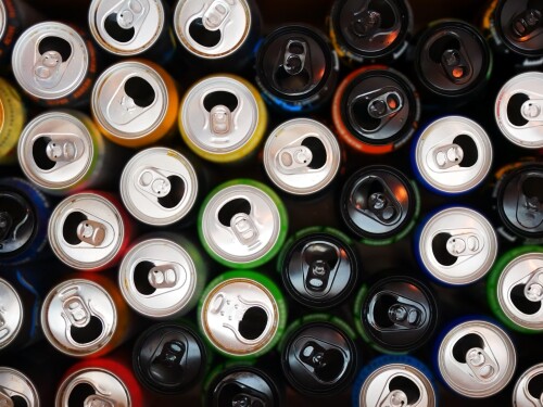 Many opened and drunk cans of different energy drinks