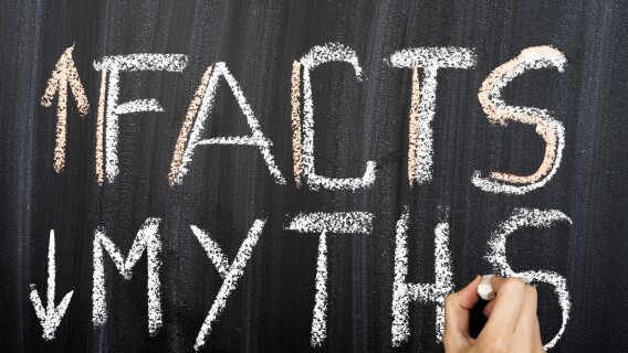 Myths and facts written on a chalkboard, money myths