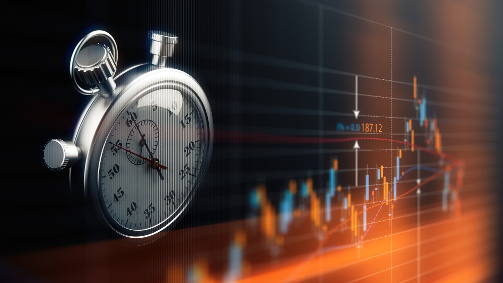 Stopwatch and stock chart, market timing and time in the market