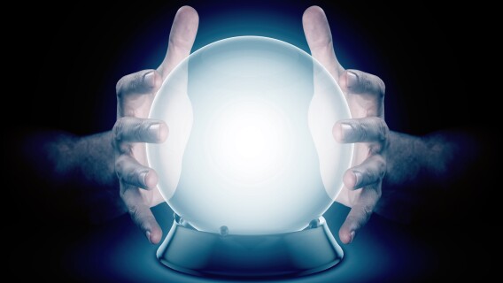 Two hands on a crystal ball representing the adage that markets are never wrong but opinions are