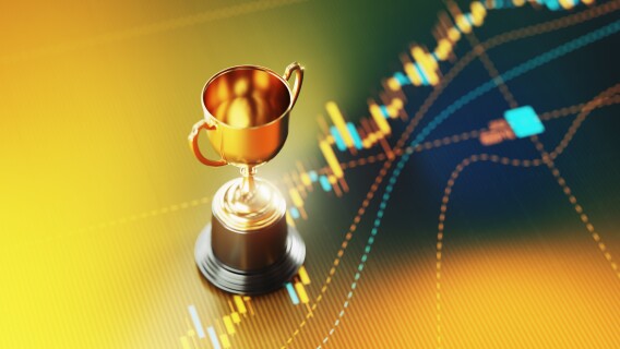 Gold Trophy Sitting On Yellow Financial Graph for the greatest trader of all time