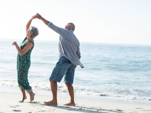 Senior couple dancing at the beach