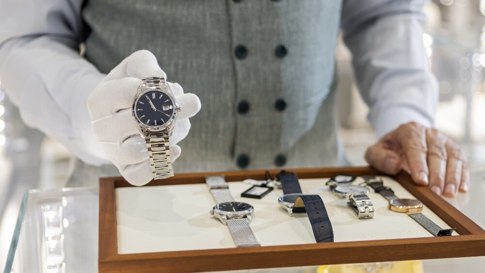 Unrecognizable person man in jewelry store selling luxury watches luxury watch stocks