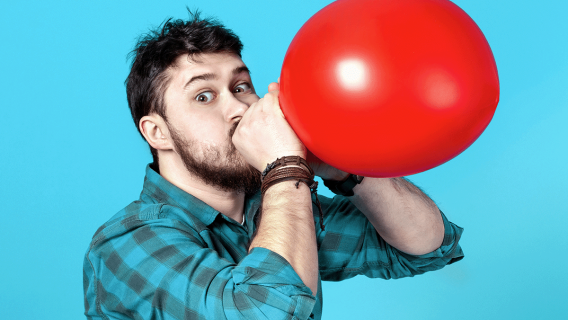 Man Blowing Up Balloon
