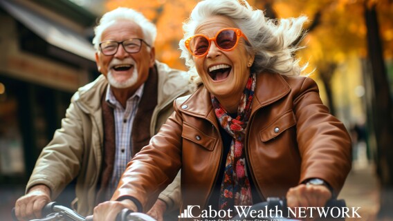 A Mature Couple Riding Bike and Laughing Together