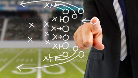 man in suit drawing football plays, investing lessons football, nfl, playoffs