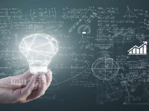 illuminated light bulb, signaling smarter investing with math, ratios, calculus peg ratios on chalkboard