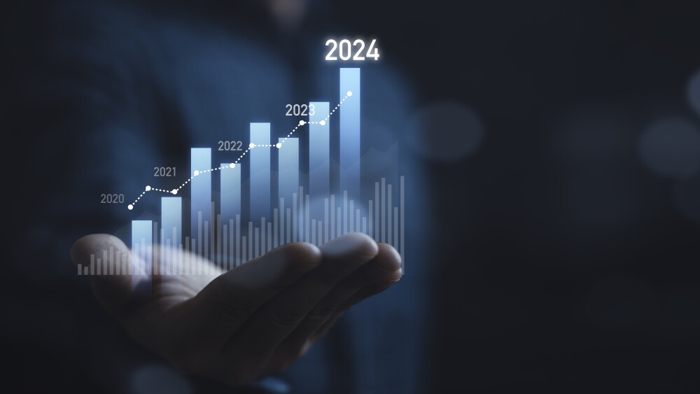 Businessman holding glowing virtual technical graph and chart; stocks; thoughts on the market in 2024, technology investment and growth investment concept.
